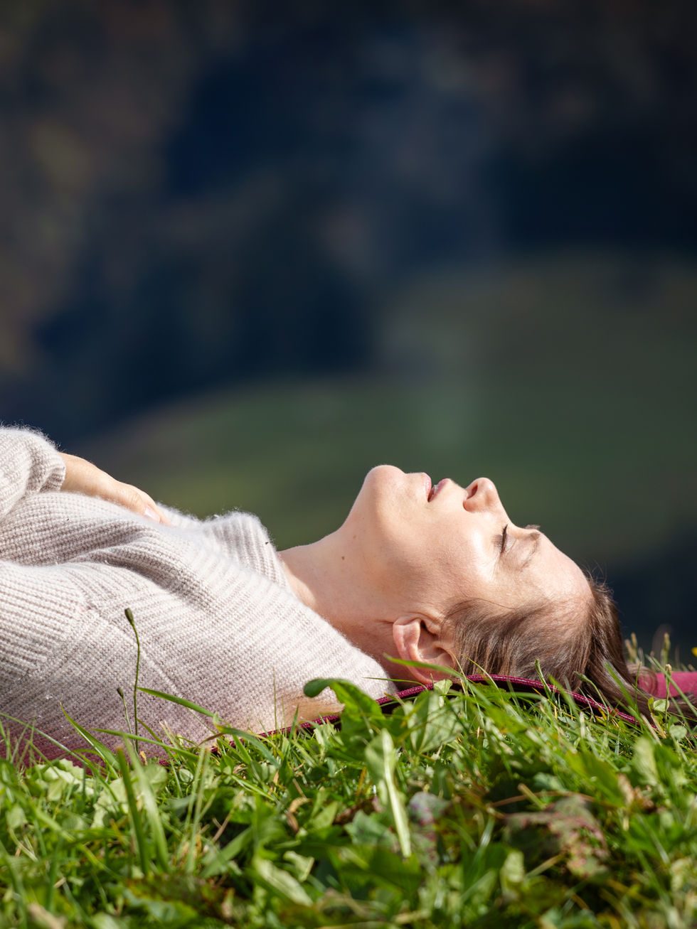 Petra lying in the grass, eyes closed